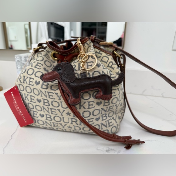 Dooney & Bourke Ivory and Brown Bucket Bag with Dachshund Leather Charm
